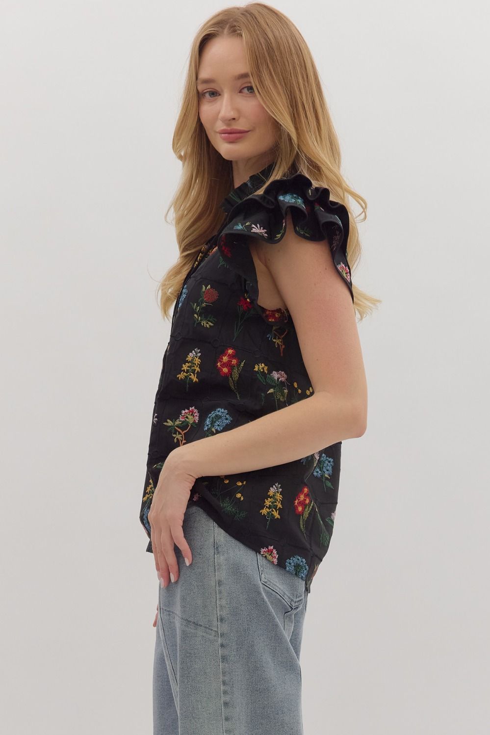Feminine and lightweight, the Claudette top features flutter sleeves, a tiered silhouette, and a piped split neckline with button detail.