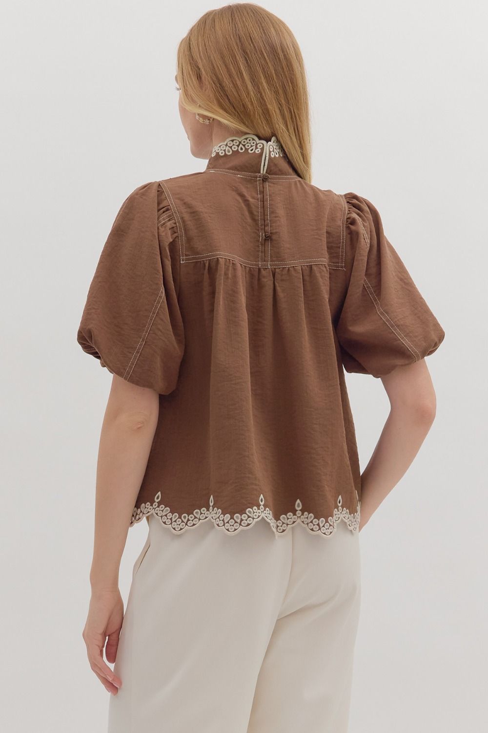 The Isolde top features romantic puff sleeves and scallop embroidered trim for a timeless, feminine finish.