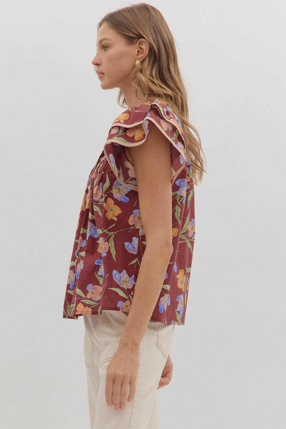 Delicate and airy, the Amelie top features flutter sleeves, pleated details, and contrast binding for feminine charm.