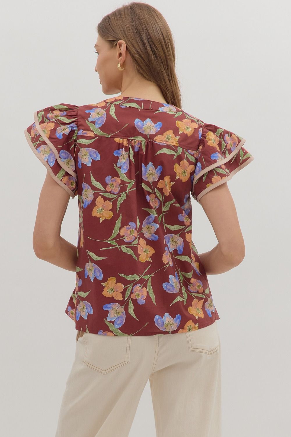 Delicate and airy, the Amelie top features flutter sleeves, pleated details, and contrast binding for feminine charm.