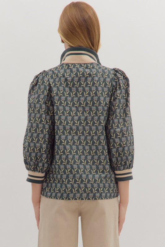 Sporty meets feminine in the Astrid top, featuring floral print puff sleeves with striped ribbed trim and a modern half-zip neckline.