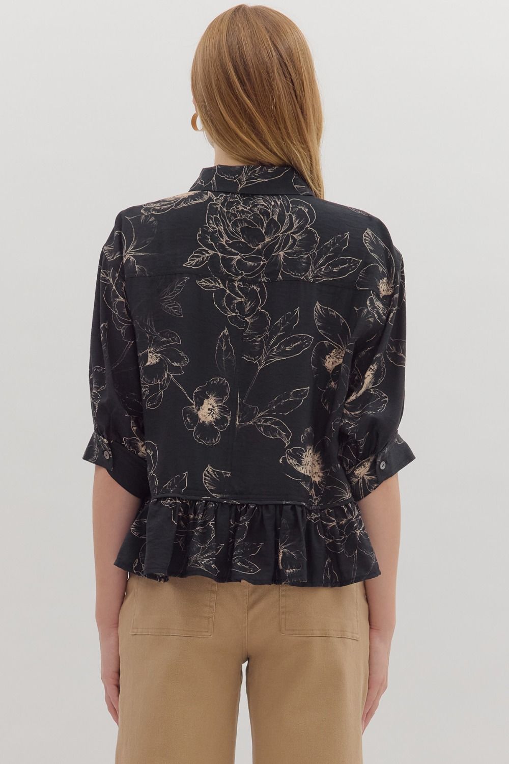 Feminine and flowy, the Colette top charms with its floral print, ruffle hem, and versatile roll-tab sleeves.
