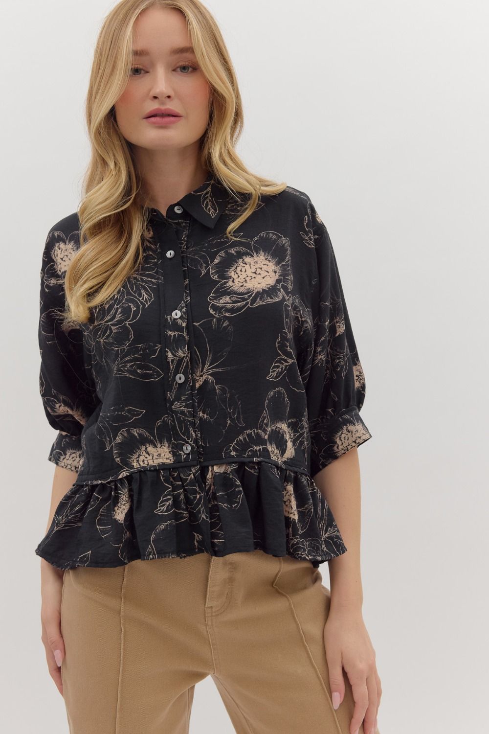 Feminine and flowy, the Colette top charms with its floral print, ruffle hem, and versatile roll-tab sleeves.