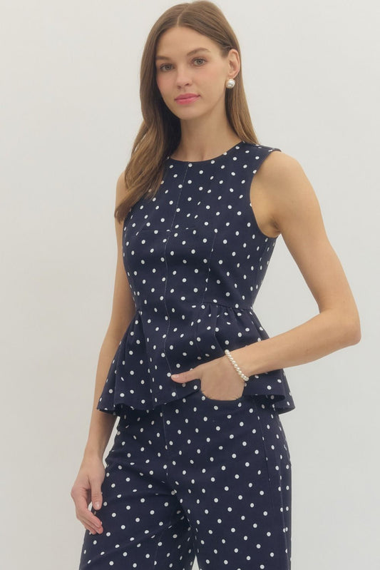 sleeveless polka dot top with a flattering peplum hem and tailored fit