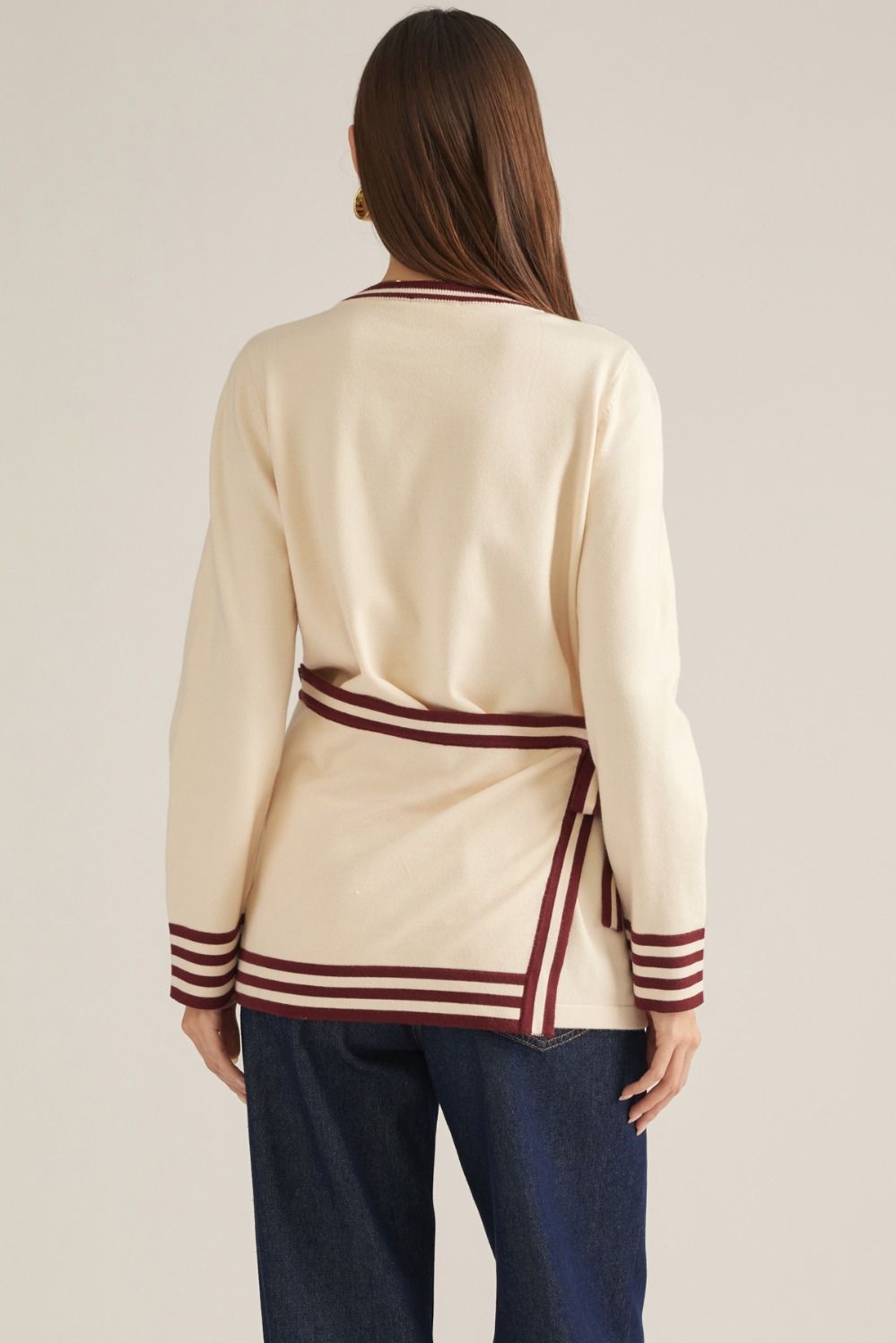 Solid long sleeve knit sweater top with contrast stripe trim and detachable wrap-style waist panel with self-tie detail
