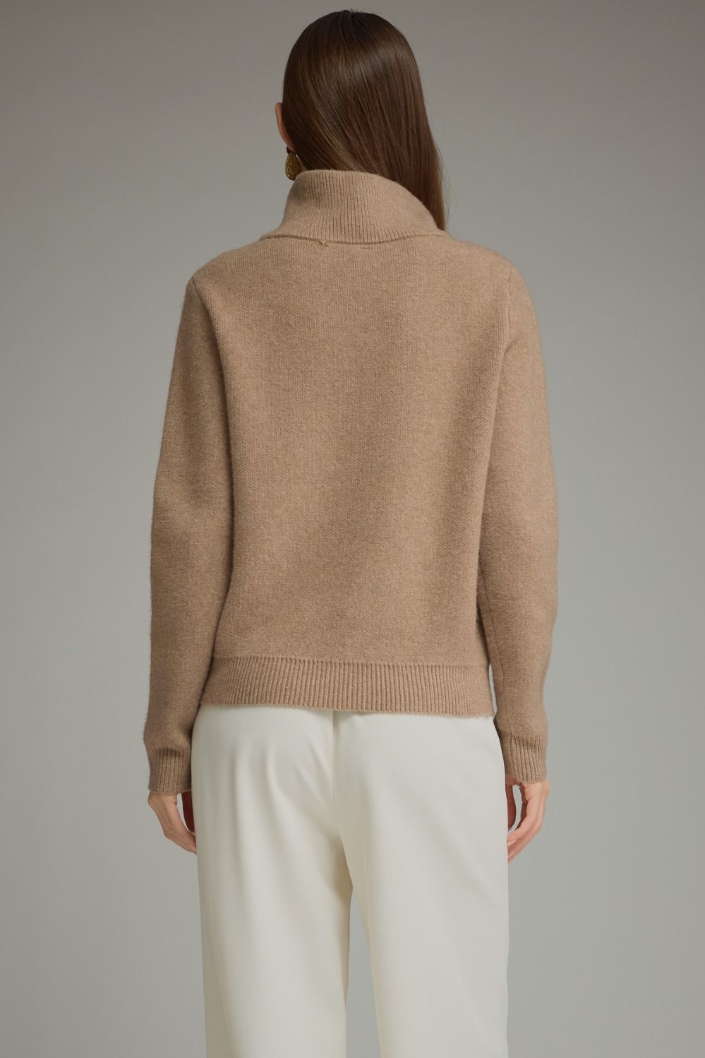 Solid long sleeve knit sweater top with stand neckline, button-front closure, and front pockets featuring buckle trim