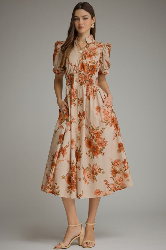 A feminine floral midi dress featuring short puff sleeves, a chic stand collar, a front zipper, and a flattering smocked waist.