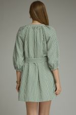 A timeless gingham mini dress featuring ¾ sleeves, a self-tie waist belt, and a button-front design for effortlessly polished style.