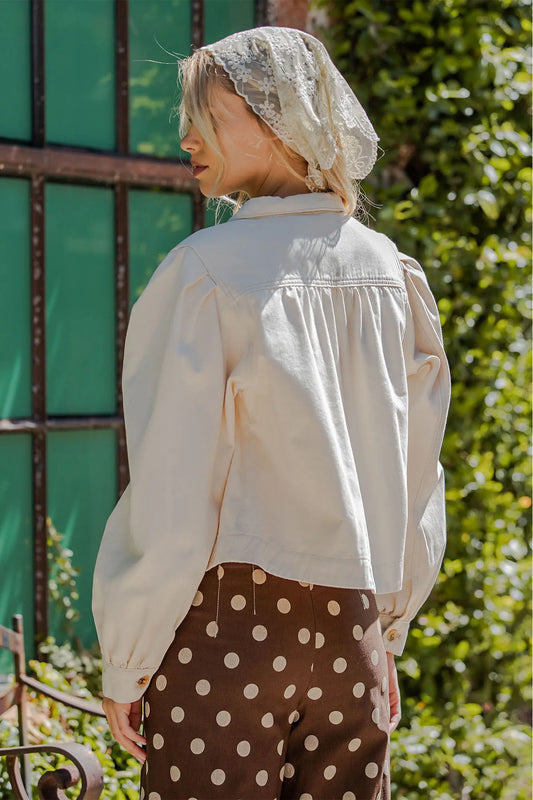 A contemporary mineral washed cropped jacket featuring voluminous sleeves, a classic pointed collar, and feminine back yoke detailing for effortless everyday style.