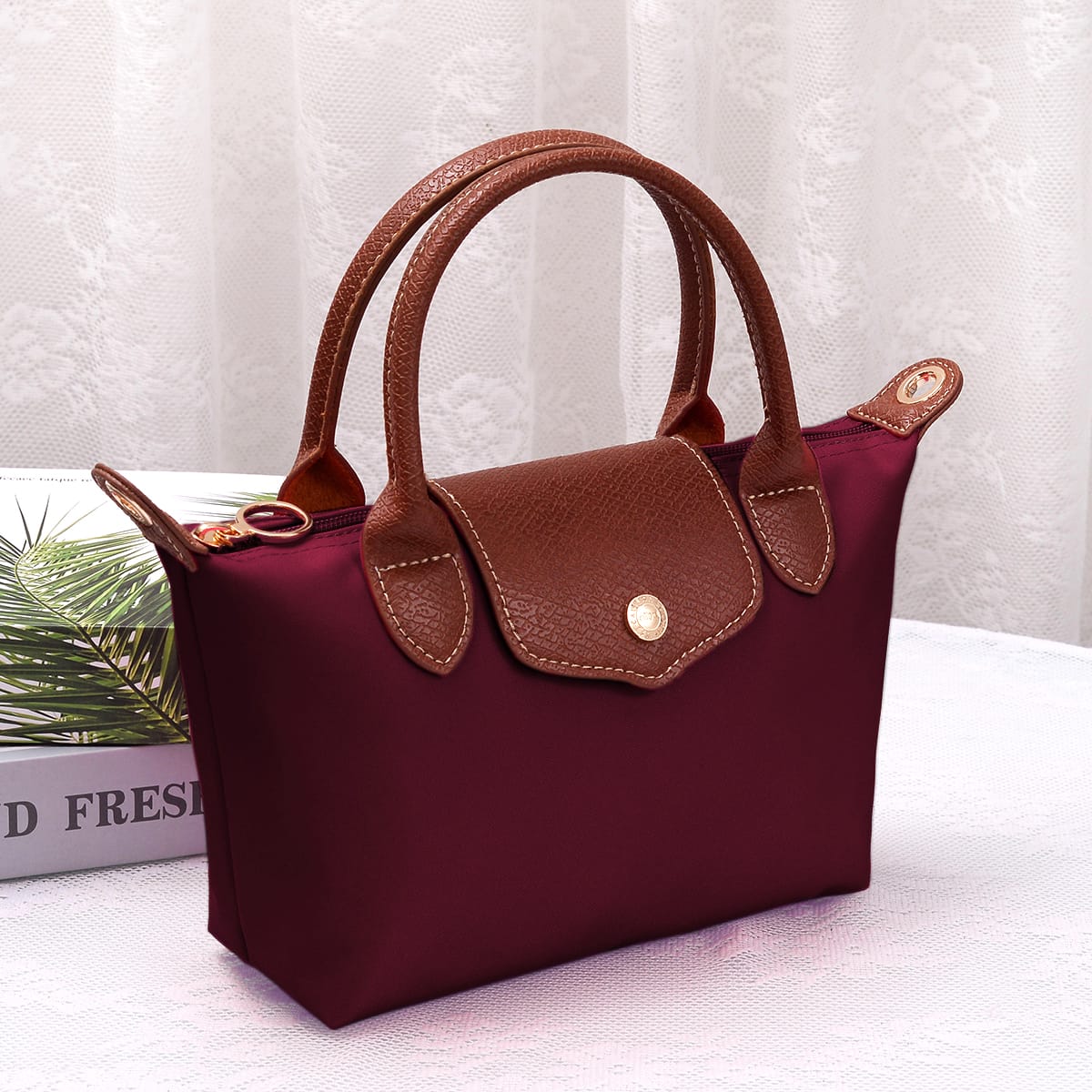 A lightweight, versatile nylon crossbody bag featuring double handles for easy carrying and effortless everyday style.
