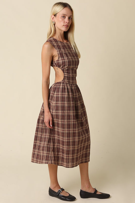 A romantic gingham maxi dress featuring an open-back tie detail, flattering fit-and-flare silhouette, and timeless plaid pattern for effortless feminine style.