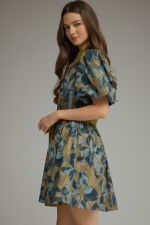 A charming floral mini dress featuring puff sleeves, a button-front design, and a self-tie waist for effortless feminine style.