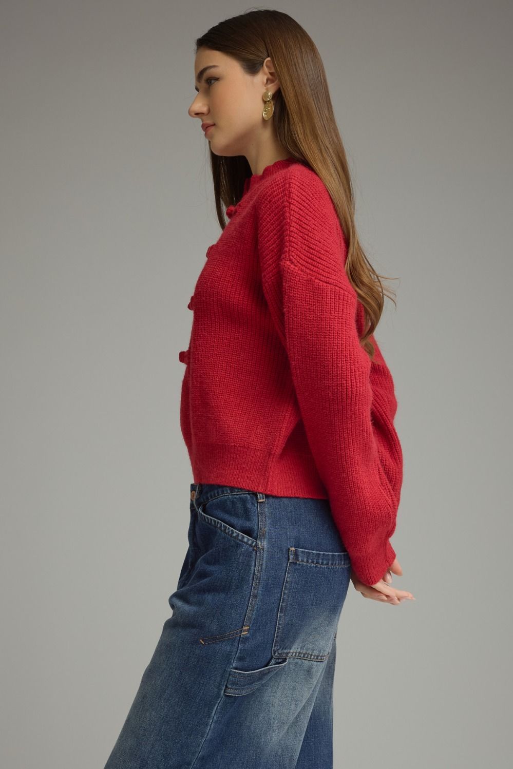 A cozy, polished sweater featuring a high neckline, statement frog-button closure, and relaxed drop shoulders for timeless style with a modern twist.