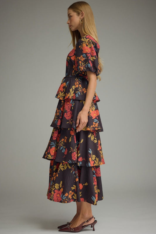 A feminine floral midi dress featuring charming puff sleeves, a flattering drawstring waist, and an effortlessly flowing tiered silhouette.