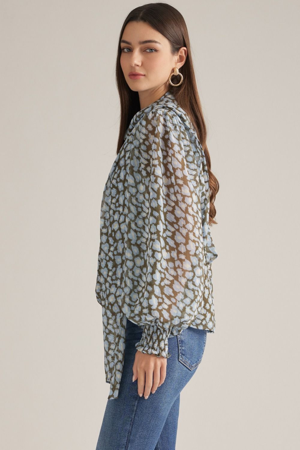 A chic leopard print top featuring dramatic balloon sleeves, a feminine self-tie neckline, and comfortable smocked cuffs for an effortlessly stylish look.