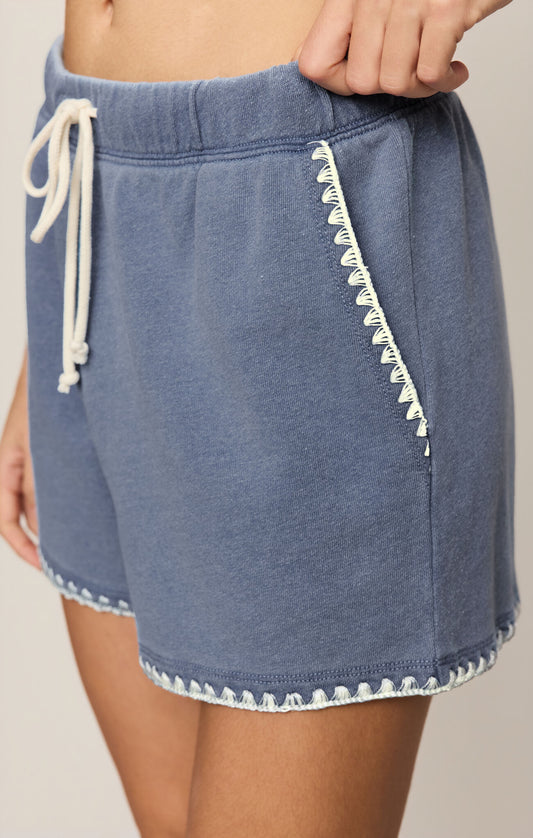 High-rise women’s knit denim French terry shorts featuring an elastic drawcord waistband, side seam pockets, and soft cotton blend fabric for comfortable casual wear.