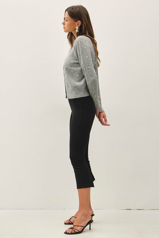 a light gray knit cardigan with small white embroidered dots and button-front closure, crew neckline,