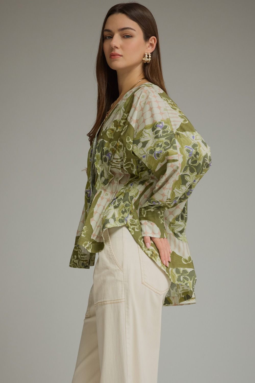 A feminine printed top featuring dramatic balloon sleeves, a flattering V-neck, and a self-tie waist that creates a beautiful peplum silhouette.