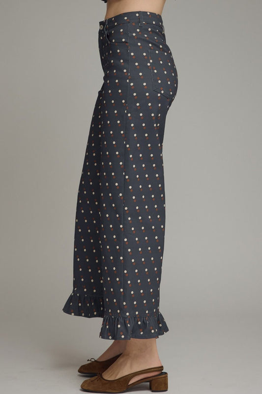 Make every outfit memorable with these playful polka dot denim pants featuring a flattering straight-leg silhouette and feminine ruffle hems.