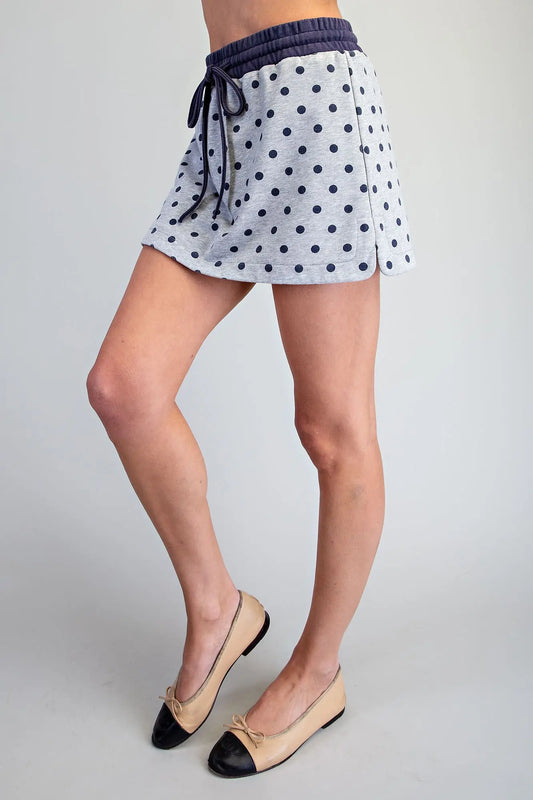 A playful mineral washed skort featuring a classic polka dot print, built-in shorts, and a comfortable drawstring waistband for effortless everyday style.