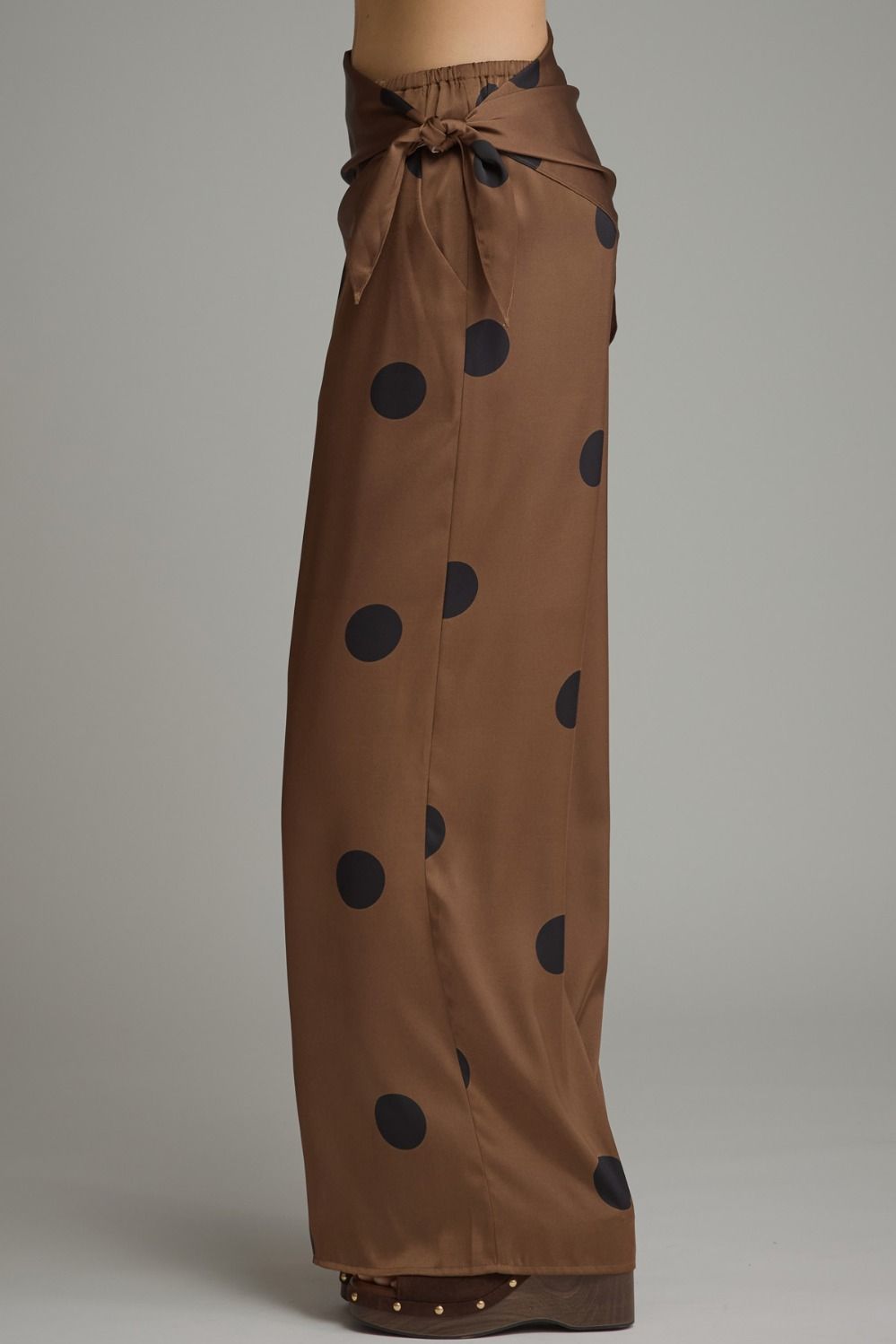 Feminine polka dot wide leg pants featuring a stylish self-tie wrap waist, comfortable elastic back, and convenient side pockets.