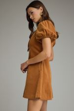 A feminine and effortlessly flattering mini dress featuring a V-neckline, romantic puff sleeves, convenient side pockets, and an easy front zipper closure.