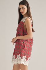A charming plaid mini dress featuring a delicate lace yoke, lace-trimmed hem, and convenient side pockets for feminine everyday style.