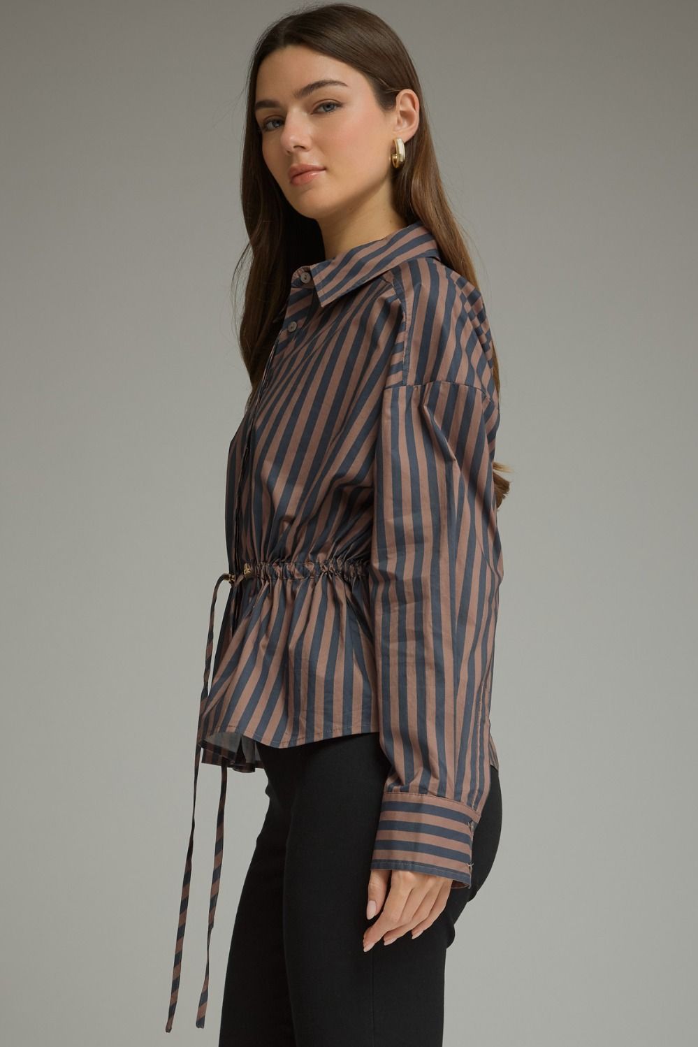 A polished striped top featuring a classic shirt collar, adjustable drawstring waist, button cuffs, and a flattering peplum hem.