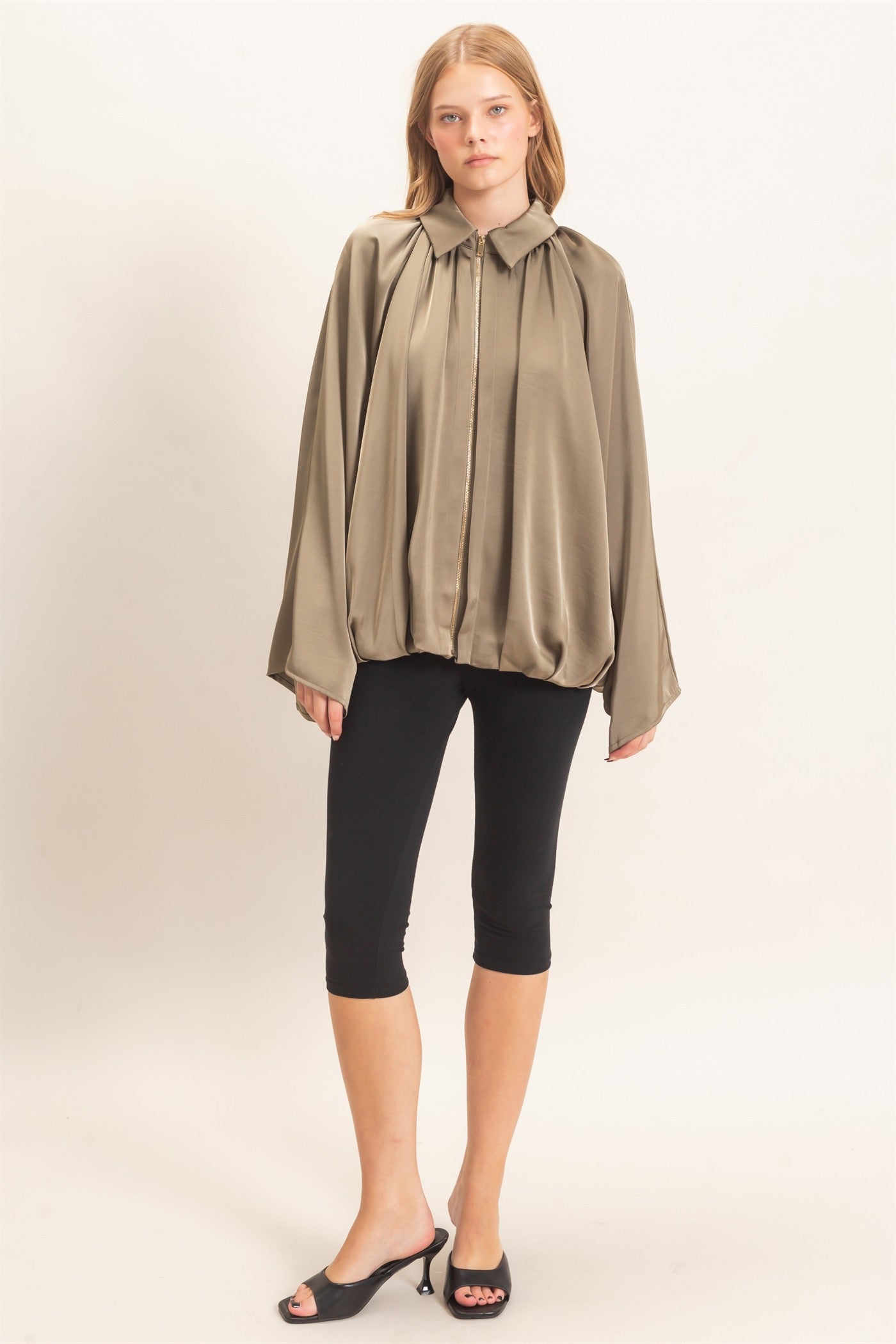 A chic satin jacket with a voluminous balloon silhouette, polished collar, and concealed zipper for an effortlessly elevated finish.
