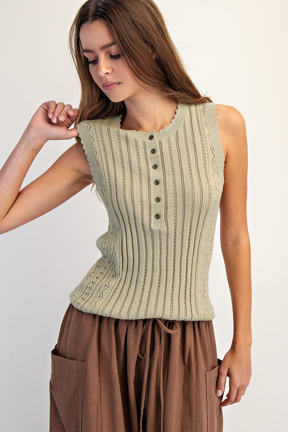 sleeveless pointelle knit top with scalloped edges and front button closure