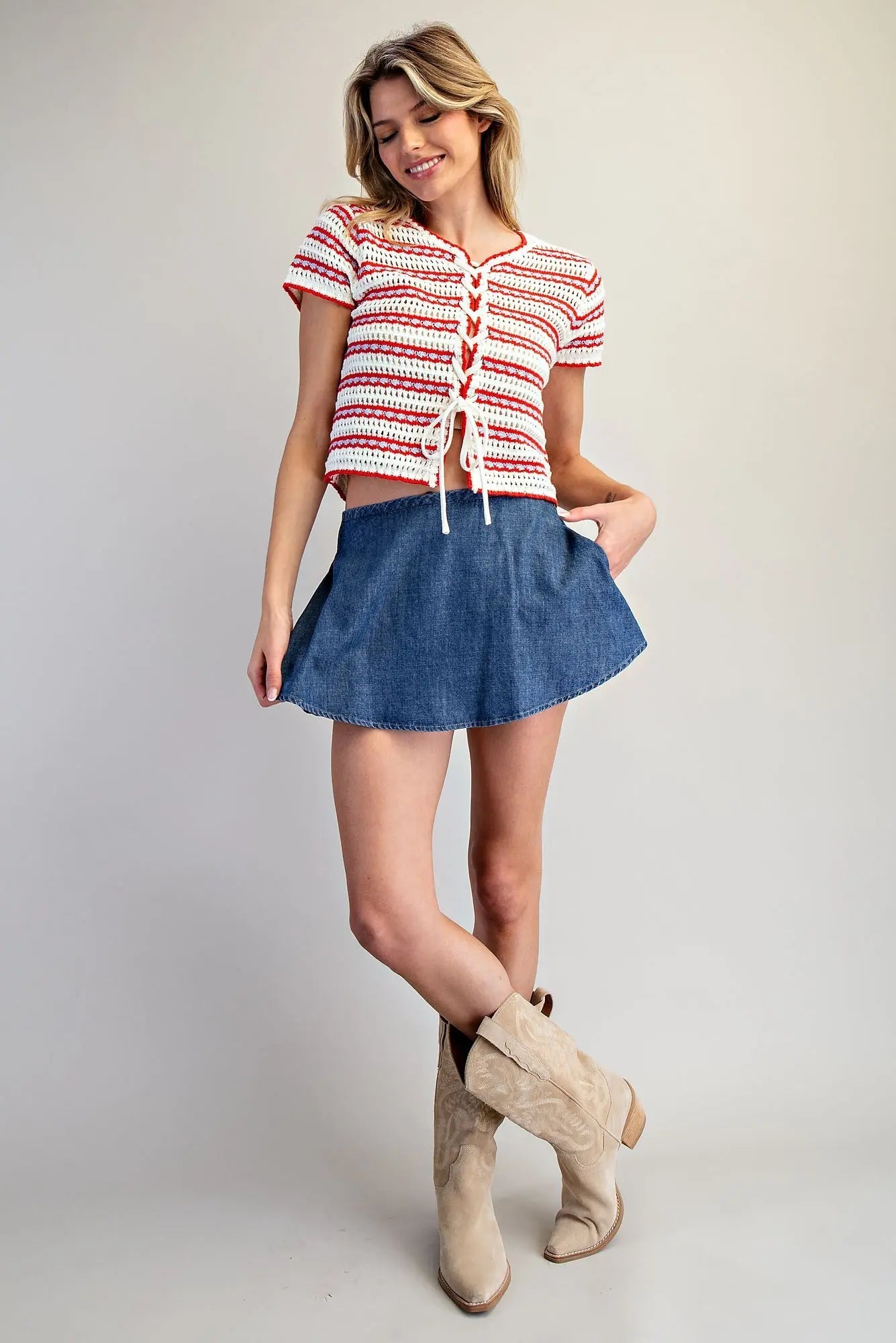 A mineral-washed denim skort with a smocked waistband, built-in shorts, and a flared A-line silhouette.