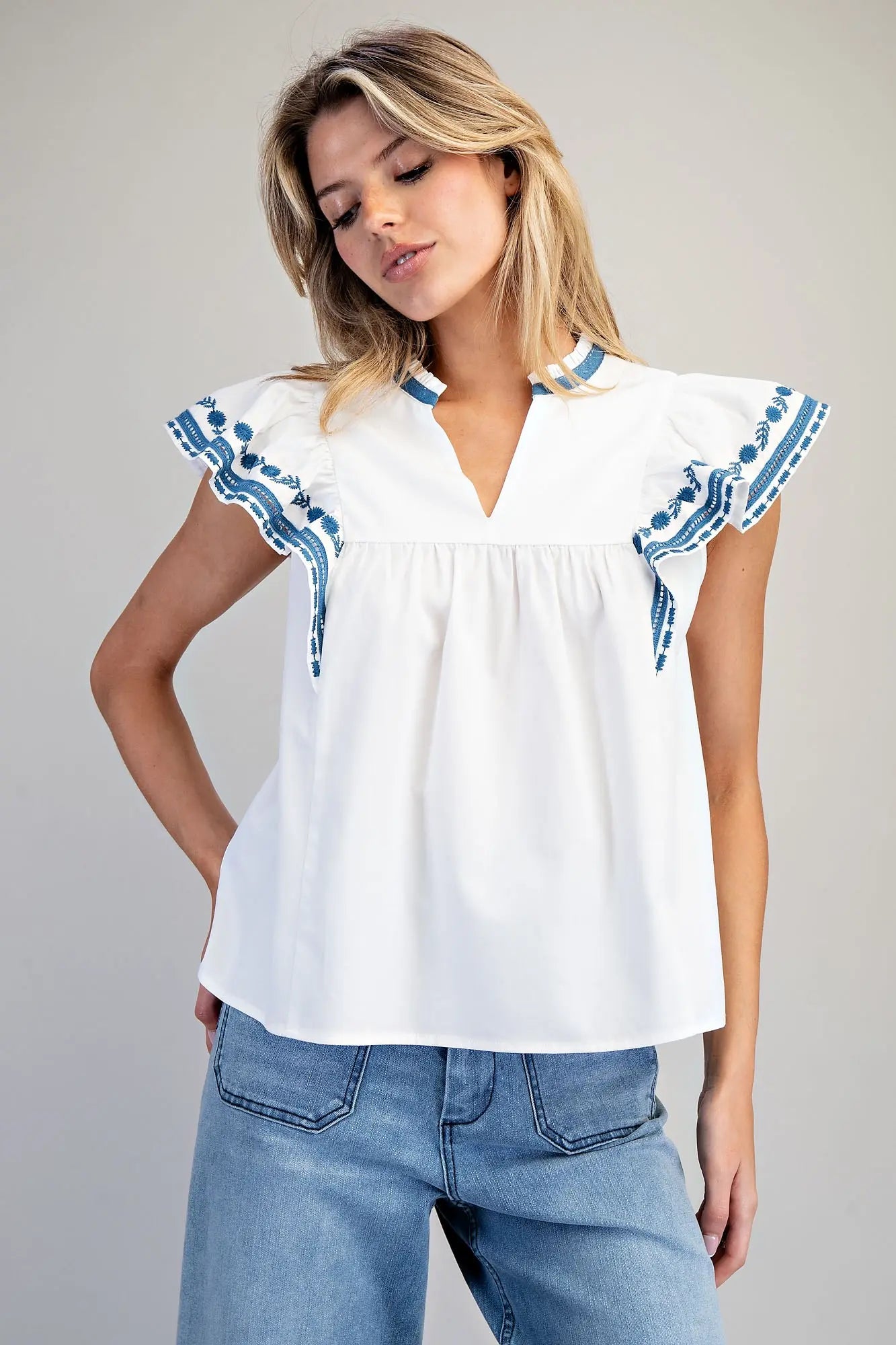 Sleeveless split v-neck top with embroidered flutter sleeves