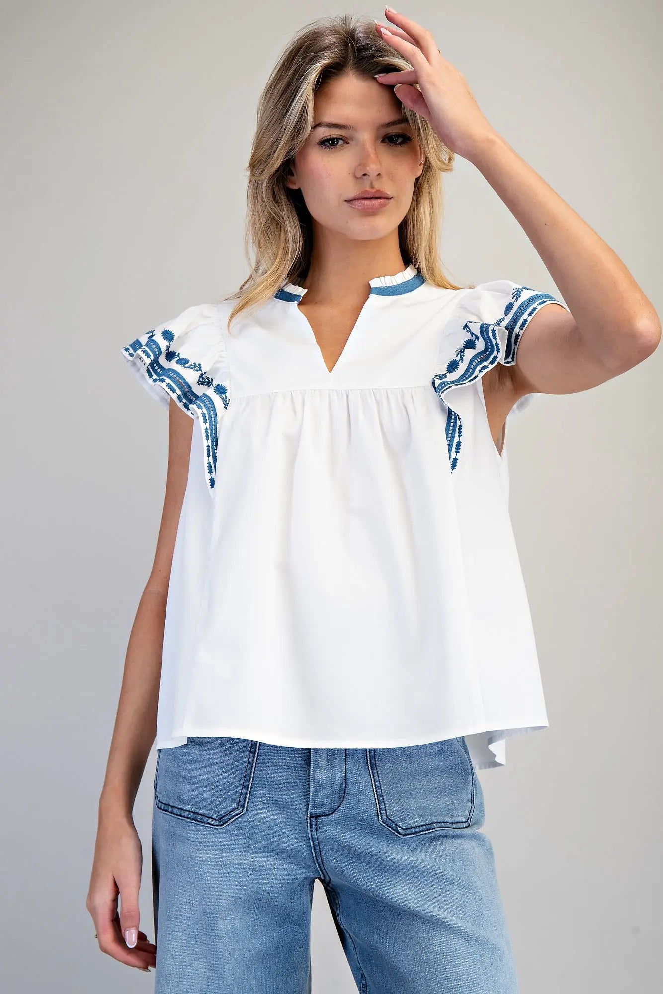 Sleeveless split v-neck top with embroidered flutter sleeves