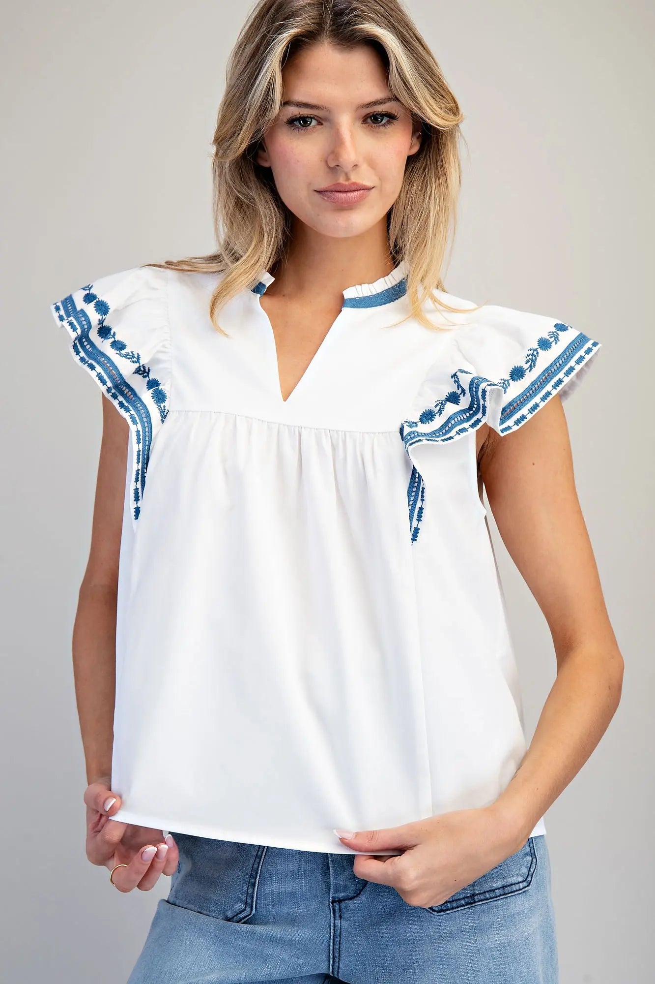 Sleeveless split v-neck top with embroidered flutter sleeves