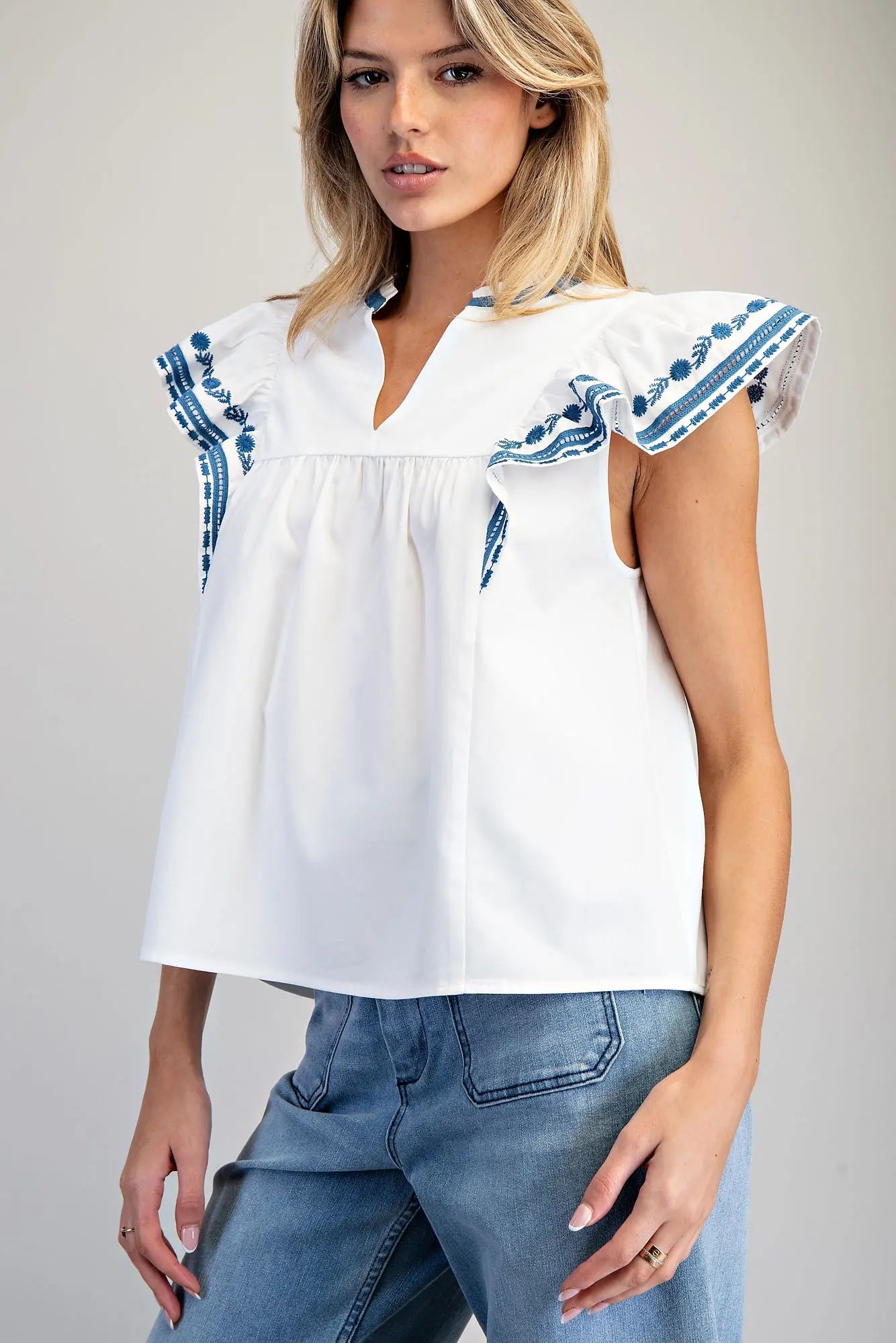 Sleeveless split v-neck top with embroidered flutter sleeves