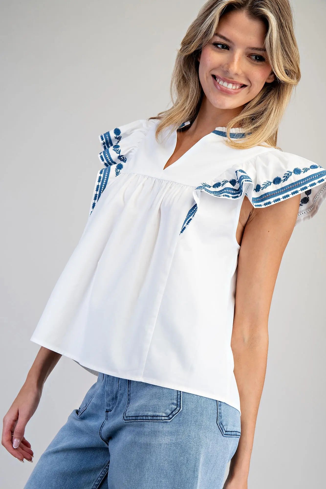 Sleeveless split v-neck top with embroidered flutter sleeves