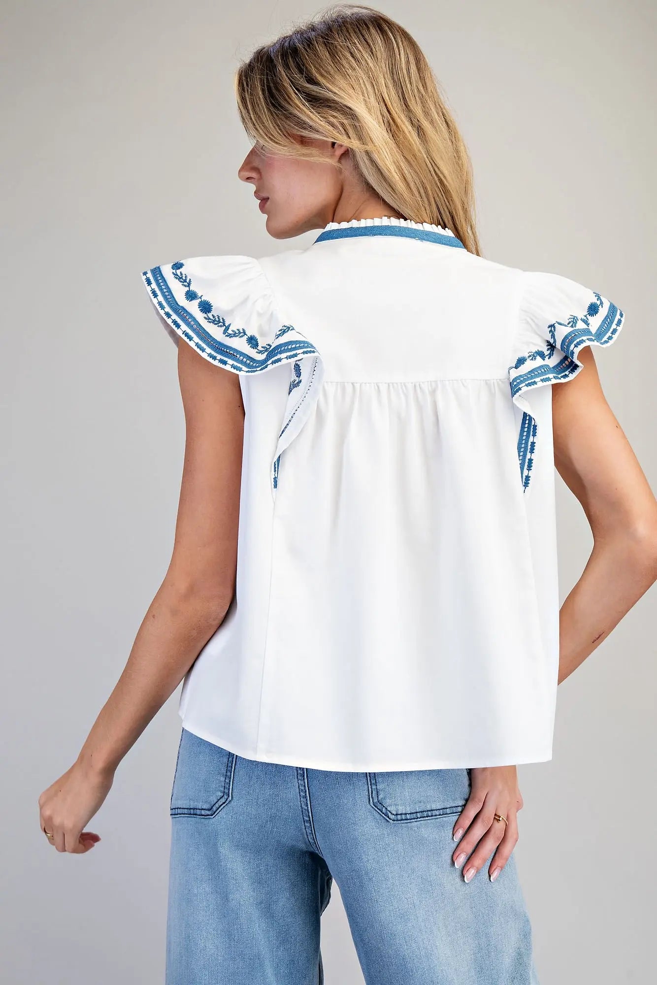 Sleeveless split v-neck top with embroidered flutter sleeves