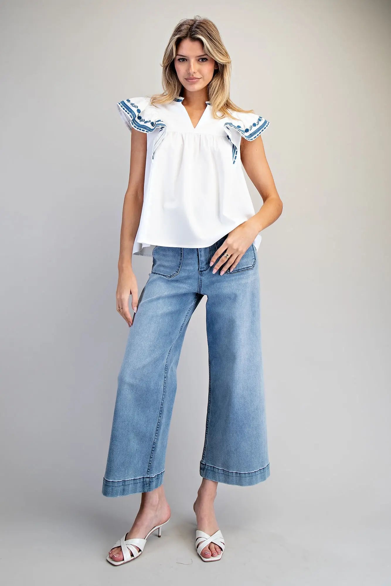 Sleeveless split v-neck top with embroidered flutter sleeves