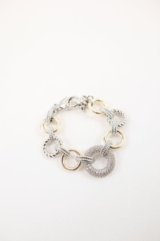 Two-tone gold and silver statement bracelet with textured links and pavé circle detail, women’s boutique mixed metal jewelry.
