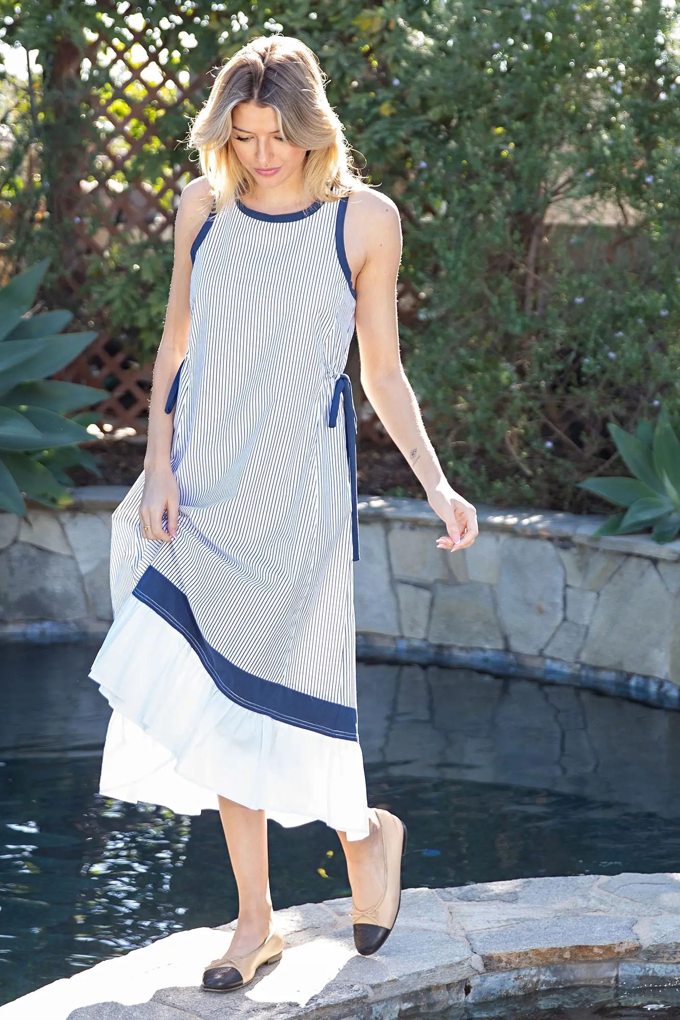 striped cotton midi dress with contrast trim, adjustable side ties, and a softly tiered hem