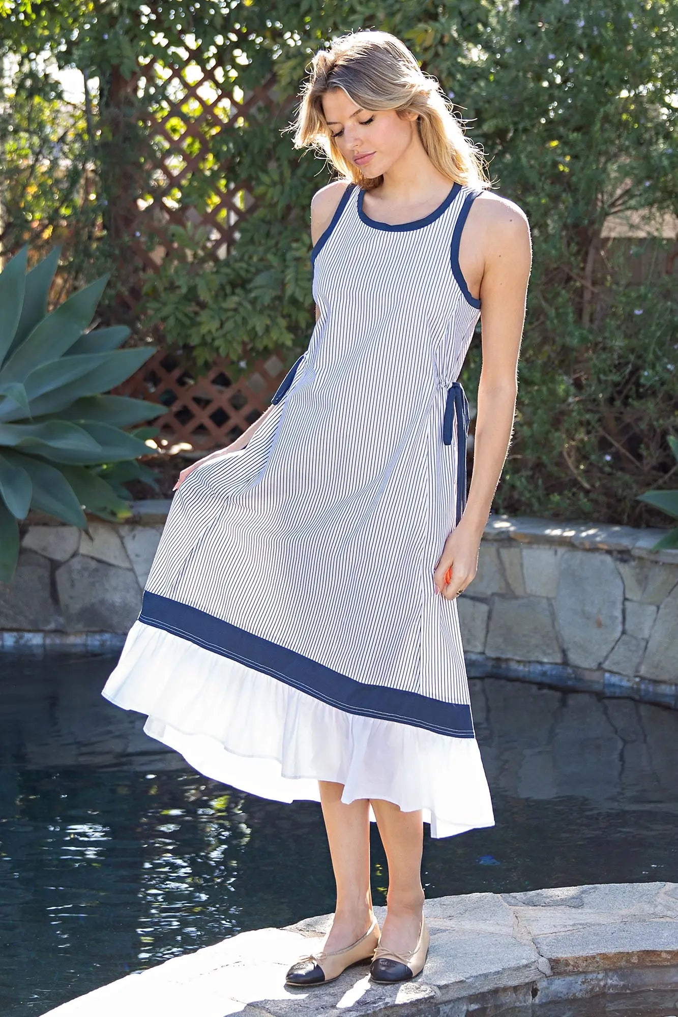 striped cotton midi dress with contrast trim, adjustable side ties, and a softly tiered hem