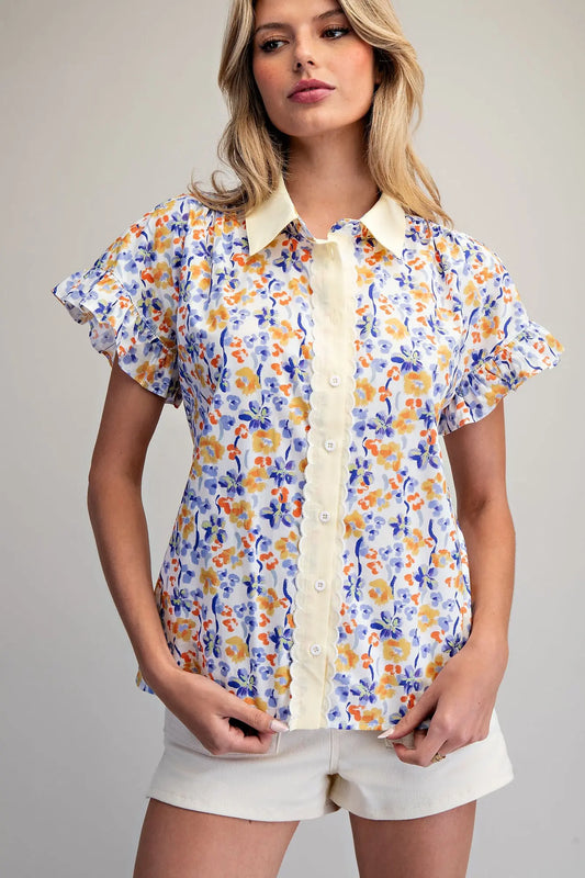 floral button-down blouse featuring flutter sleeves and delicate scalloped trim detailing