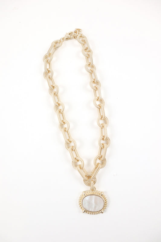 Gold textured link chain necklace with oval mother-of-pearl pendant and rope detailing, women’s boutique coastal statement jewelry.