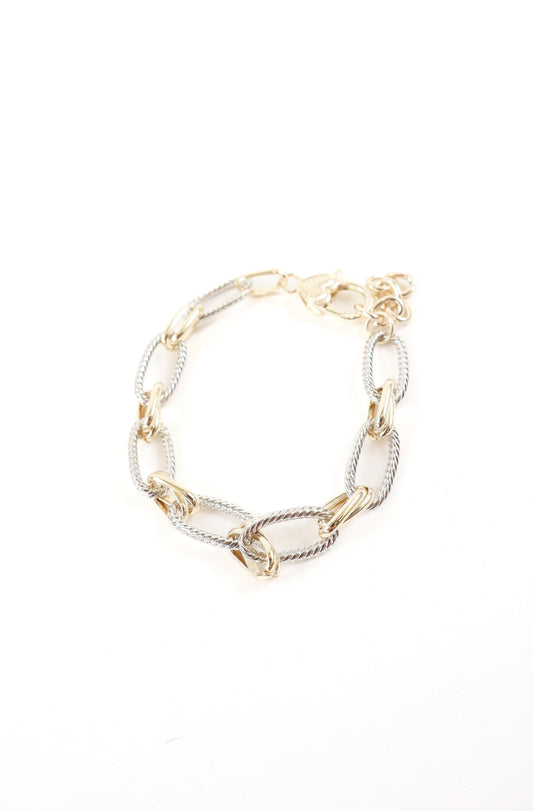 Mixed metal oversized link bracelet with gold and silver twisted chain detail, women’s boutique statement jewelry.