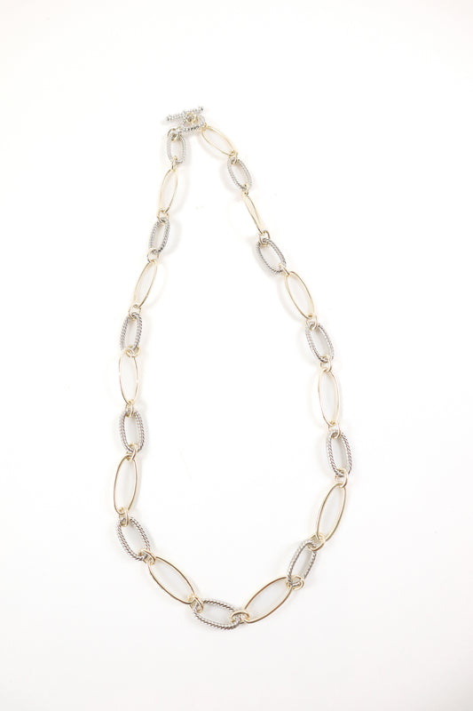 Mixed metal elongated link necklace with gold oval links and silver rope chain detail, women’s boutique statement jewelry.