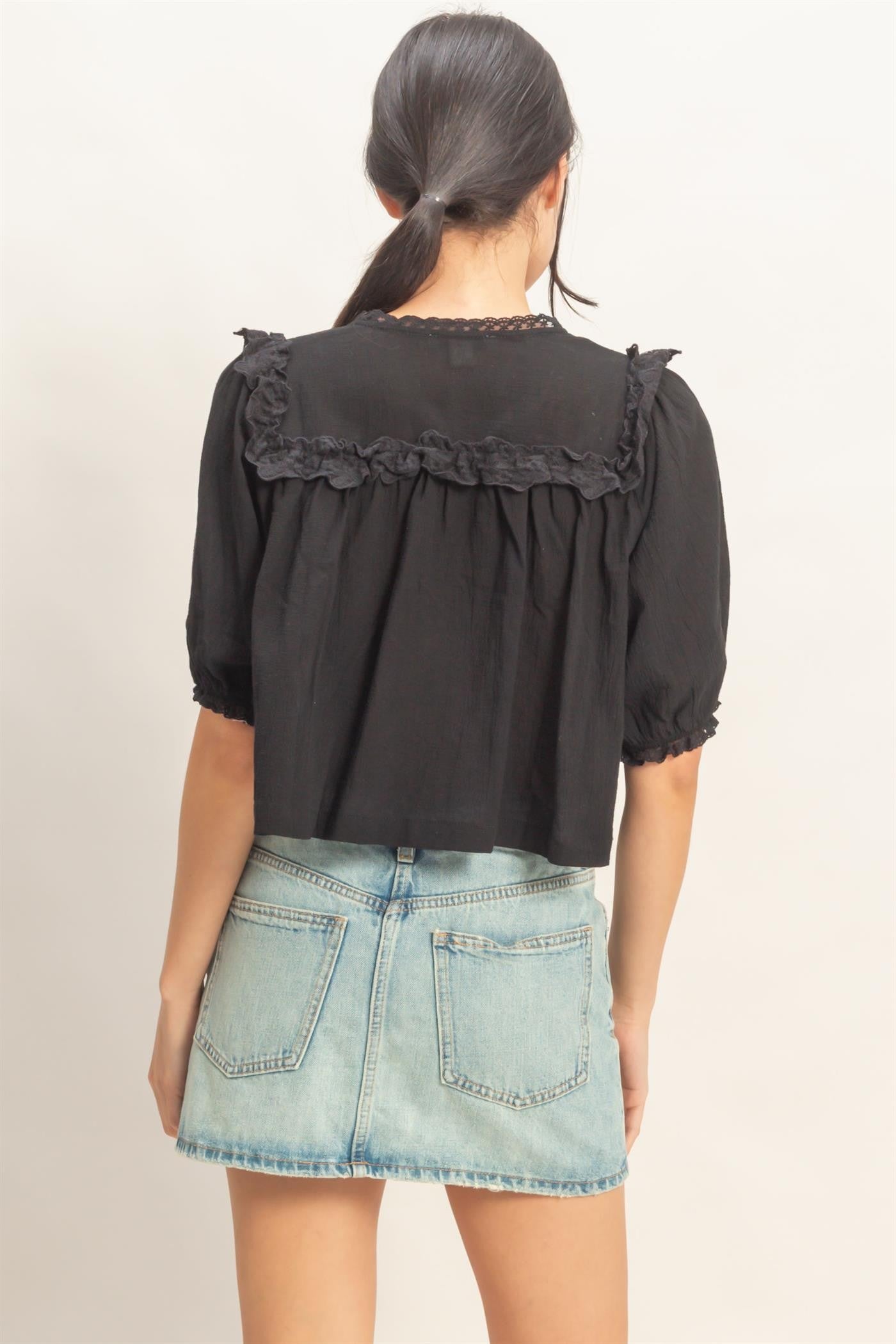  Lace Trim V-Neck Top features delicate ruffled lace accents and a relaxed silhouette 