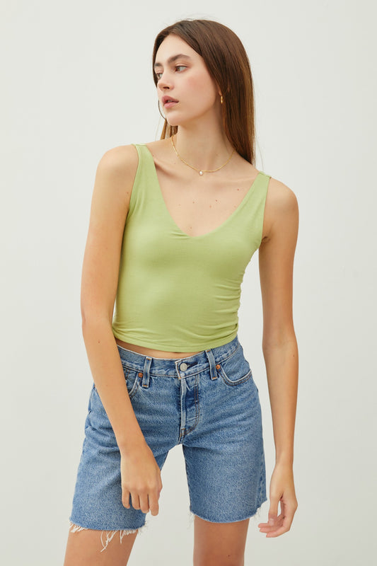 Cropped double V-neck sleeveless tank with scoop V back and stretchy rayon-spandex fabric.