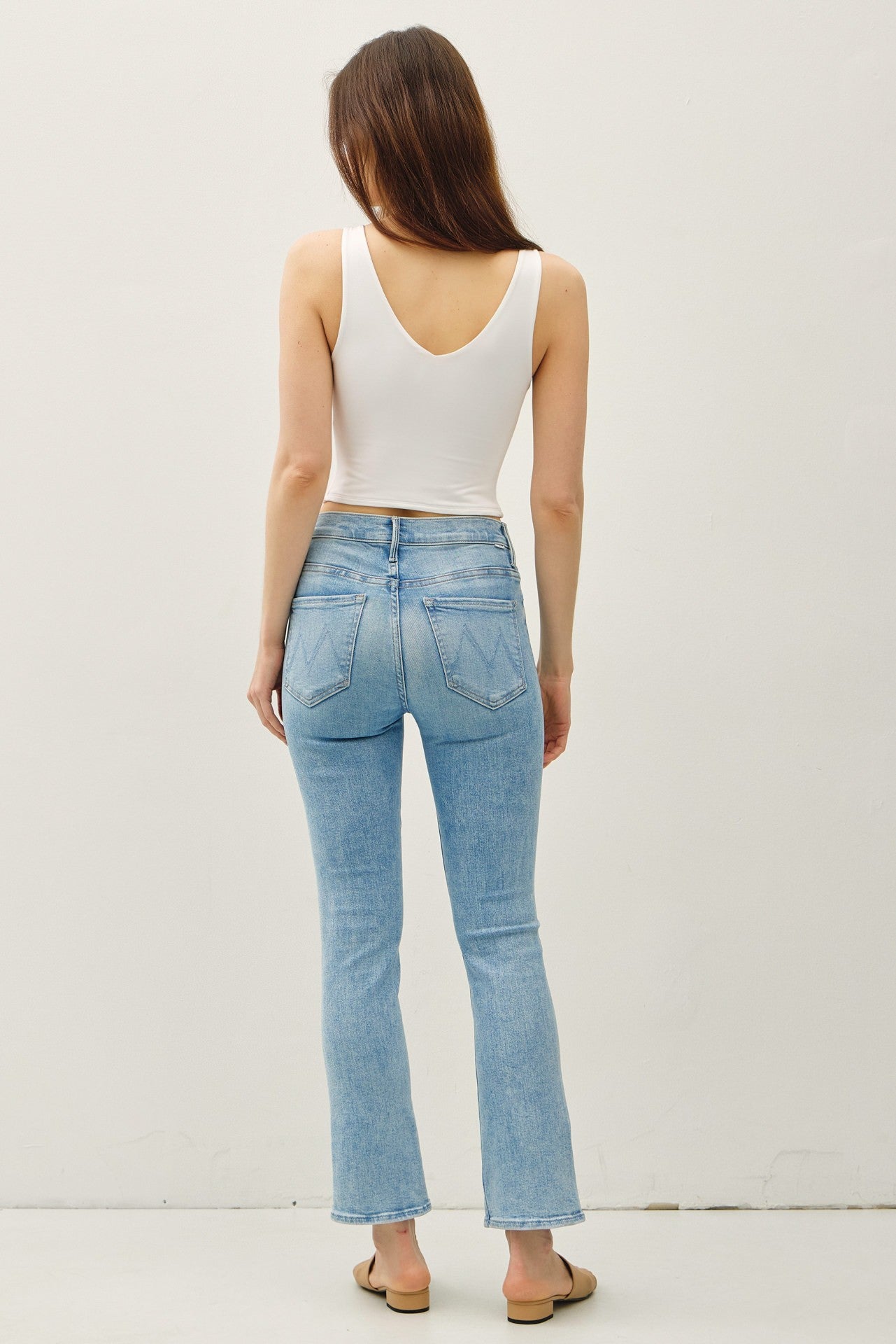 Cropped double V-neck sleeveless tank with scoop V back and stretchy rayon-spandex fabric.