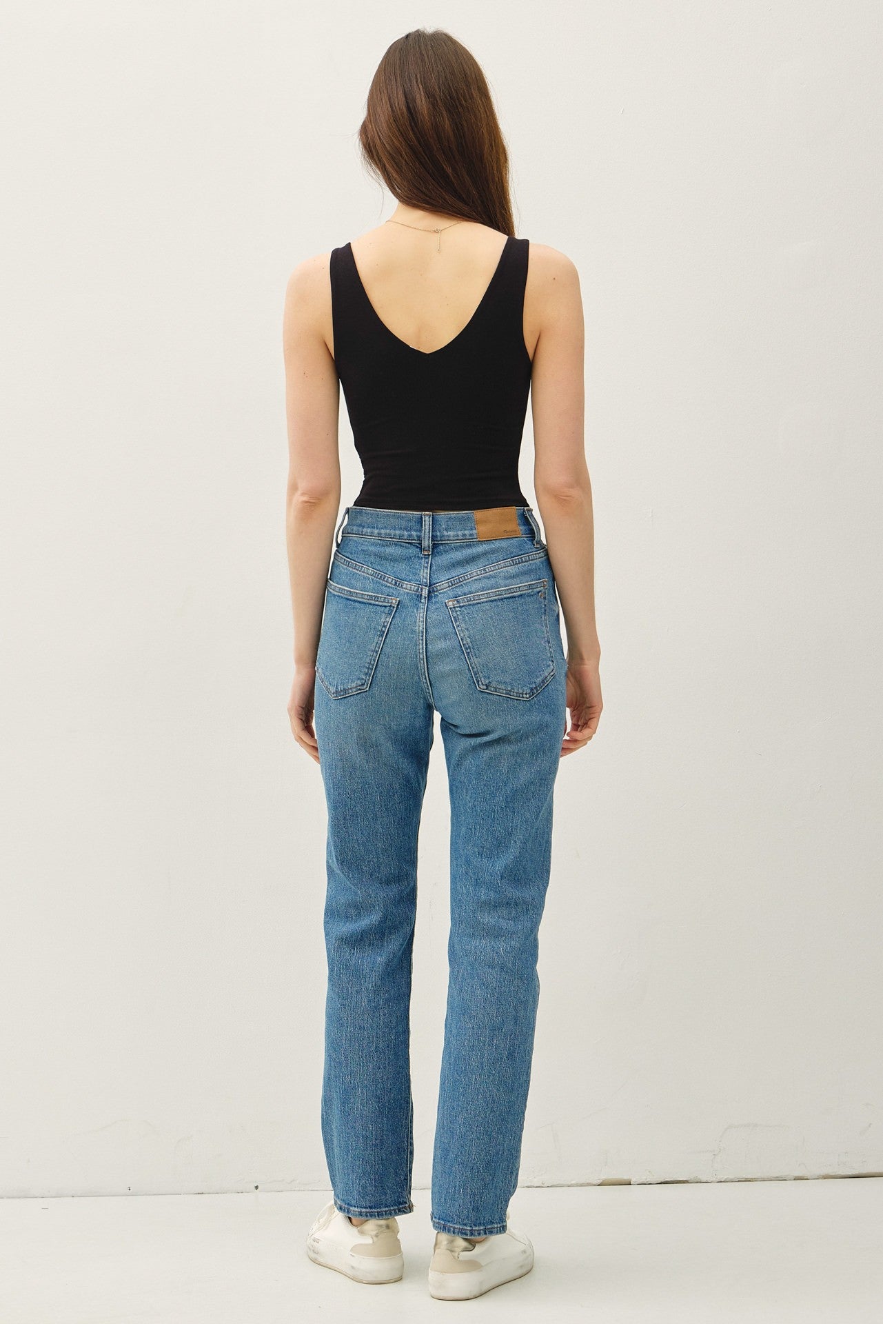 Cropped double V-neck sleeveless tank with scoop V back and stretchy rayon-spandex fabric.