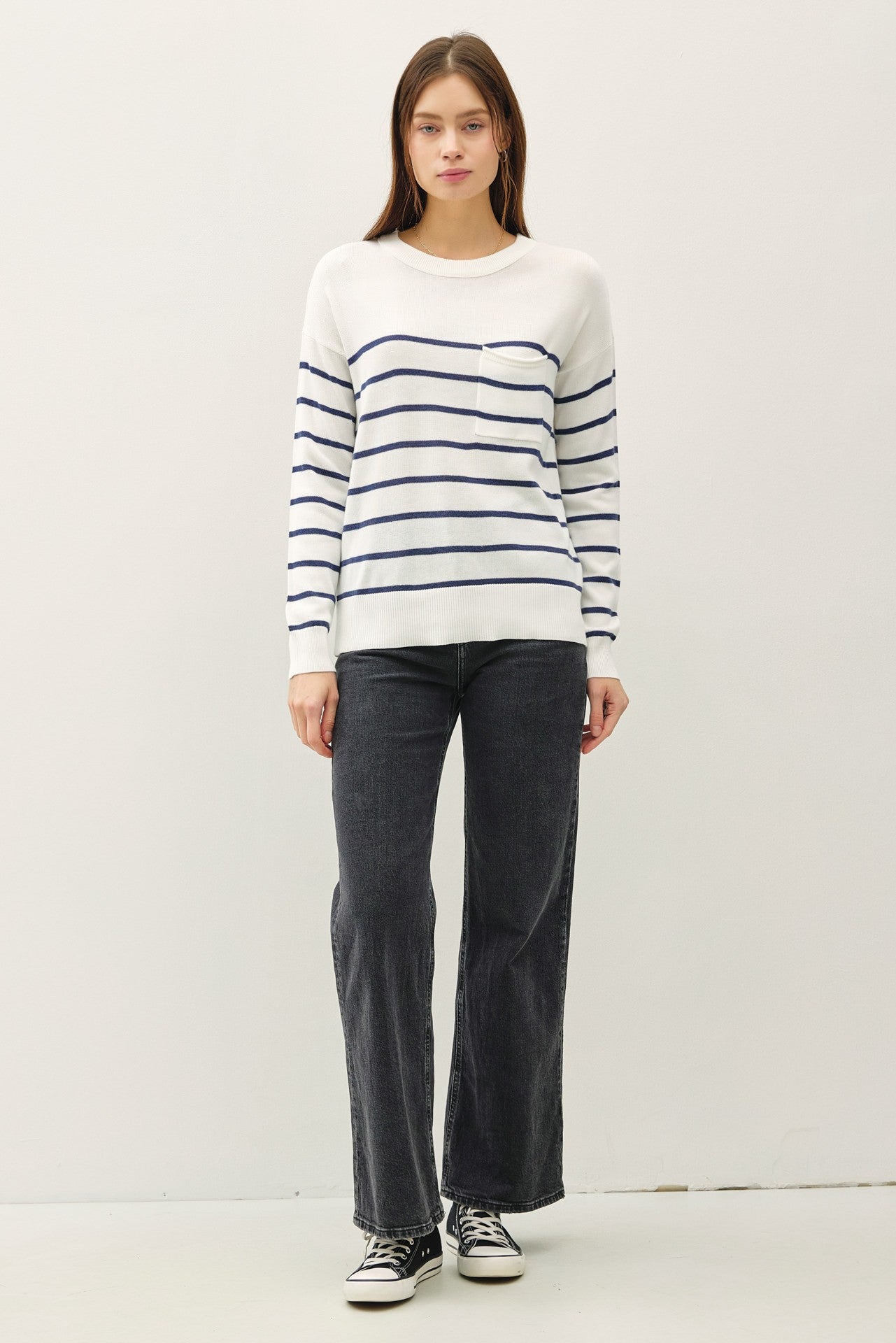 Lightweight striped sweater with round neckline and front pocket.